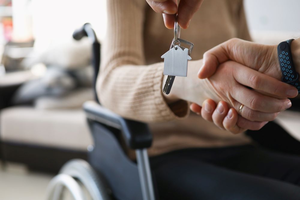 Personne en situation de handicap reçoit les clés de son logement adapté